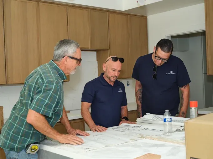 KCB Plumbing team reviewing project blueprints